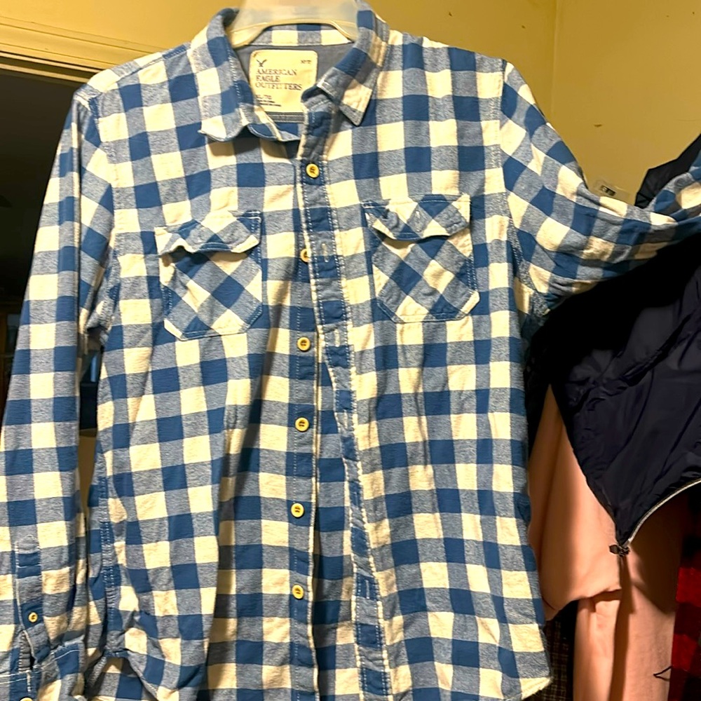 This is a blue and white flannel American eagle button down shirt